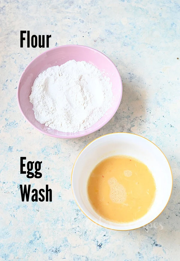 ingredients to coat chicken pieces with egg and flour