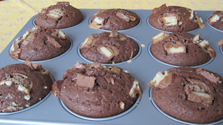 Food Lust People Love: Twix Muffins combine a sweet chocolate batter with crunchy Twix bars inside and on top for a batch of great snack muffins the whole family will love.