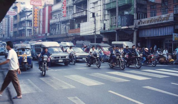 Heavy Bangkok traffic waiting at pedestrian crossing.