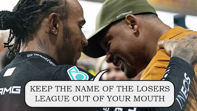 Lewis Hamilton and Will Smith huddling, Will saying "Keep the name of the Losers League out of your mouth"