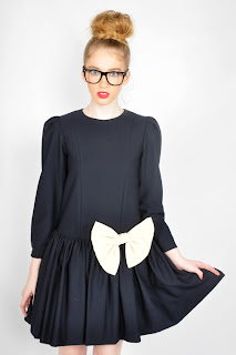 Vintage 1980's navy blue dolly dress with long sleeves and a large white bow on the front.