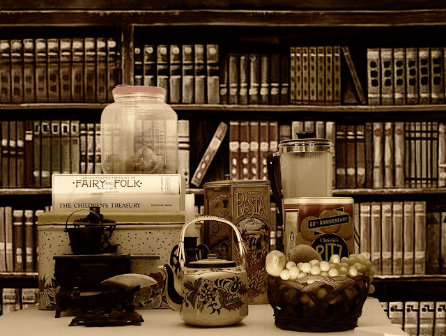 Vintage storage tins and glass jar, with a 1940s tea pot.