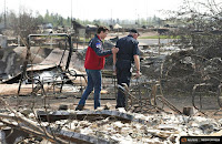 Canadian Prime Minister Justin Trudeau consoles Fort McMurray, Alberta fire chief Darby Allen in the wake of the devastating wildfire that ravaged the city. (Credit: Reuters) Click to Enlarge.