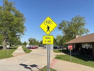 driveway into parking lot, with sign indicating "Trail Crossing"