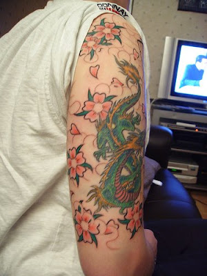 tattoo sleeve consists of cheery blossom tattoo and baby dragon tattoo