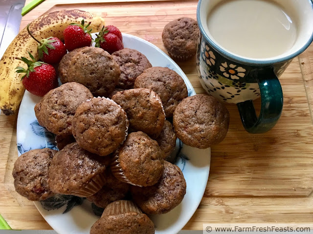 image of a plate of whole wheat strawberry banana muffins with a mug of tea