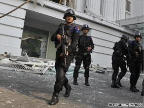 Counter-terrorist police commandos secure the damaged Ritz-Carlton hotel in Jakarta on Friday after the blasts