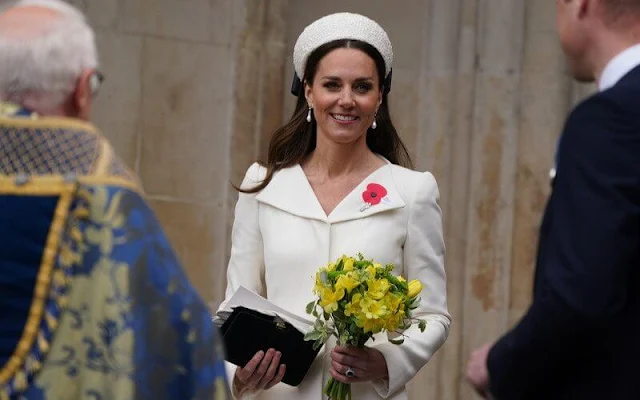 Kate Middleton wore an ivory coat dress by Alexander McQueen. Jenny Packham Roxy clutch. Jane Taylor Calypso halo headband