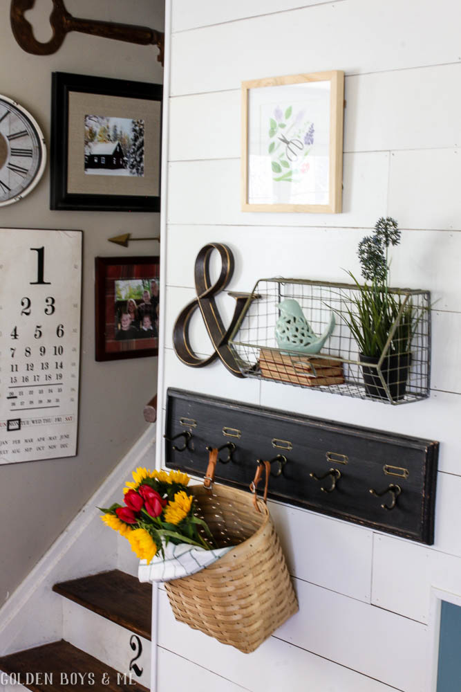 Gallery wall with wire basket and hooks in spring entry