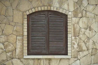 Large, arched windows with shutters