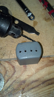 Anderson PowerPole polarity checker cap - four holes being drilled for the LED wires to pass through.