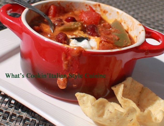 this is a crock of Guinness beer chili con carne in a red ceramic pot