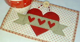 http://www.craftsy.com/pattern/quilting/home-decor/valentine-banner-mug-rug/84359