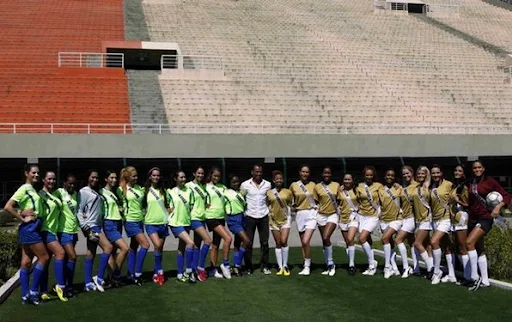 Miss Universe 2011 contestants pose for a picture after playing an exhibition football match