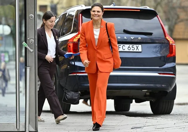 Crown Princess Victoria wore an orange shawl lapel blazer by Zara, and orange wide leg trousers by Zara