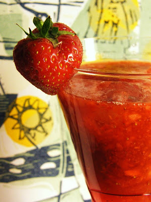 strawberry and elderflower cocktail with a fresh strawberry on the cocktail glass