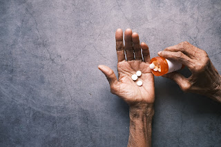 person pouring pills into their hand