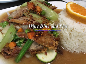 The crispy duck dish is served in a house broth sauce at Sila Thai restaurant in Saint Petersburg, Florida with rice and vegetables