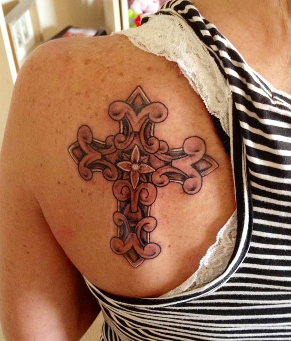 This is an amazing ornate cross tattoo design on the back shoulder to make women look beautiful