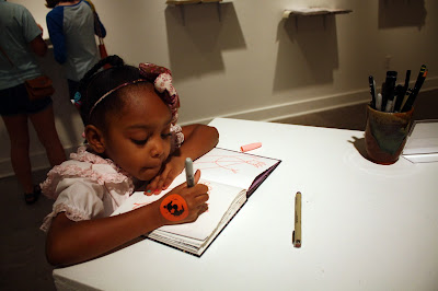 girl drawing in interactive sketchbook at Watkins College