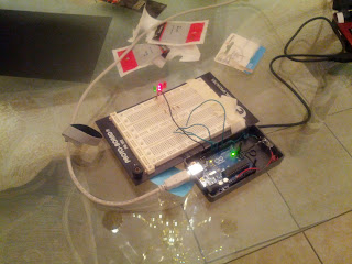 Breadboard. Arduino is connected by wires to four 220-ohm resistors, each leading to an LED, all leading to ground.