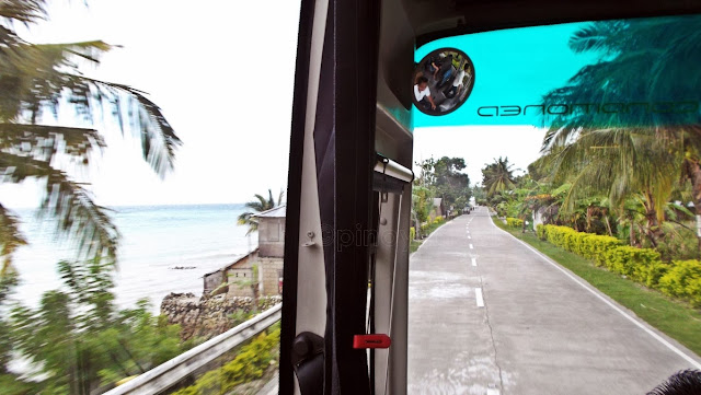 beautiful sea and highway view from a speeding ceres bus in southwestern cebu