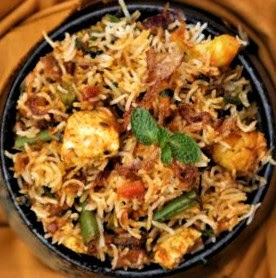 Biryani is a South Asian mixed rice dish made with spices, rice, meat (chicken, beef, goat, fish), and/or vegetables.