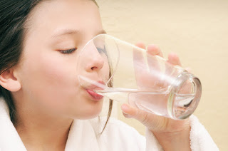 girl drinking glass of water 