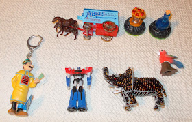 Lledo wagon, two accessories (from one of the electronic gaming systems I think?), a Tin Tin character key-ting, a robot with a Kinder 'K' but too big for a standard egg, so presumably a Maxxi-egg toy and a flocked parrot which seems modern, but it still rather clever. I was taken by the elephant made of beads thread on steel-wire, has he looks like one of the suits of elephant armour in a museum somewhere!