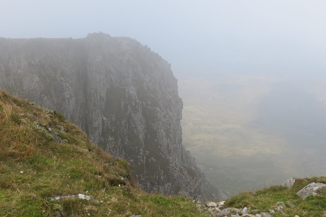 A cliff face in mist.