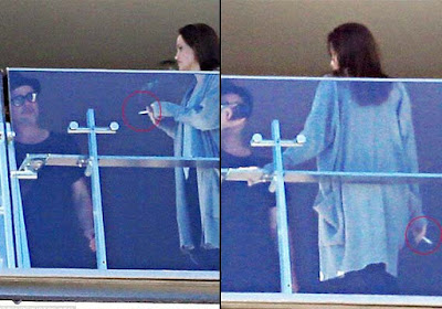 Angelina Jolie smokes a cigarette as she and Brad Pitt engage in a heated exchange