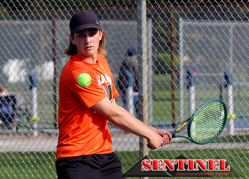 Santi Lleras hits the ball back over the net in set 1 of his match