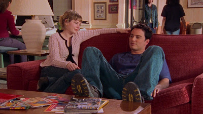 Jen looking lovingly at Jack as they sit together on the couch