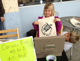 children selling canvas bags as fundraising for environmental program