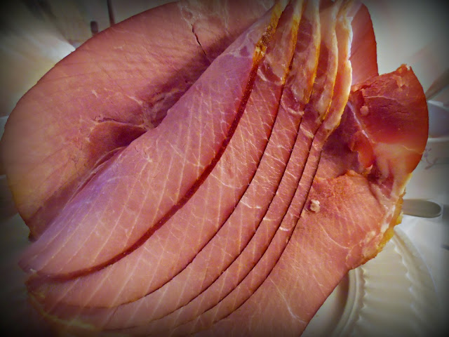 spiral sliced ham on a white platter.