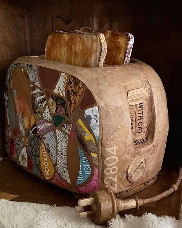 realistic altered cardboard toaster with two slices of toast standing in slots