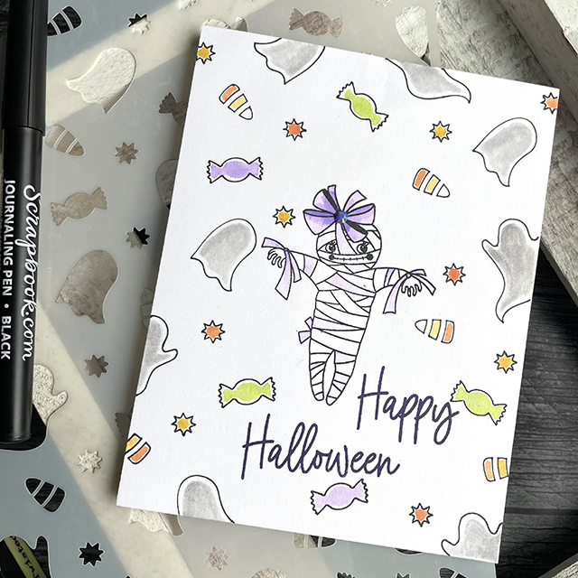 Halloween Mummy and Treats card created with: Scrapbook.com ghostly treats stencil, boo-tiful stamp set, journaling pen; Tim Holtz distress ink in fossilized amber twisted citron wilted violet crackling campfire and hickory smoke; Pinkfresh jewels