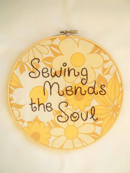hand embroidered wall art hoop featuring sewing mends the soul quote on vintage fabric