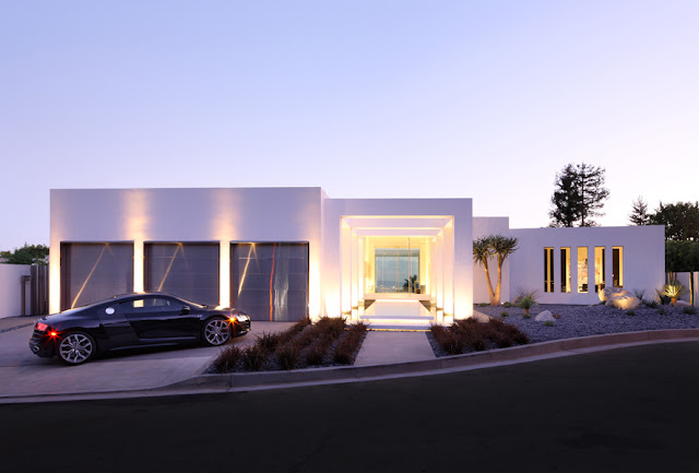 Modern home and Audi parked in front from the street 