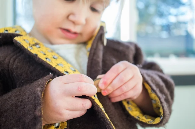 Montessori practical life - buttoning at 3-years-old