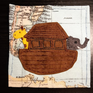 Noah's ark completed on a blue map fabric with the ark plus giraffe and elephant