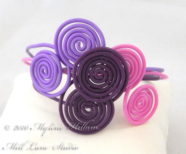 Pink and Purple interlocking spiral bracelet stack.