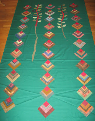 quarter log cabin blocks in possible string layout with vines and leaves