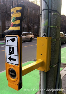 Accessible Pedestrian Signal with a tiny yellow boot on top