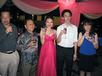 The wedding couple and parents toasting with their guest