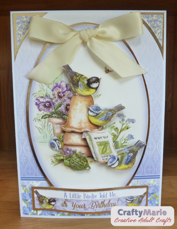 Bird greeting card with dimension and large ribbon bow detail on the front
