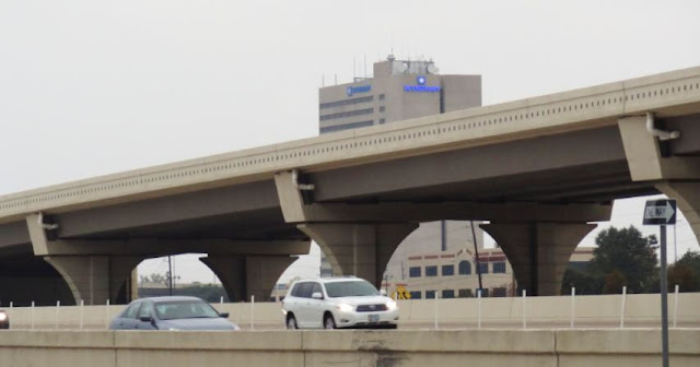 Photo of Katy Freeway elevated lane - Strayer University Building in background