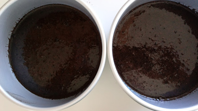 dark chocolate cake batter in two prepared cake pans