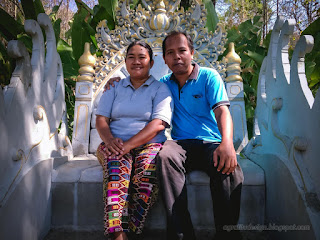 Romantic Man And Woman Sitting On A Typical Balinese Carved Seat In The Tropical Garden Park