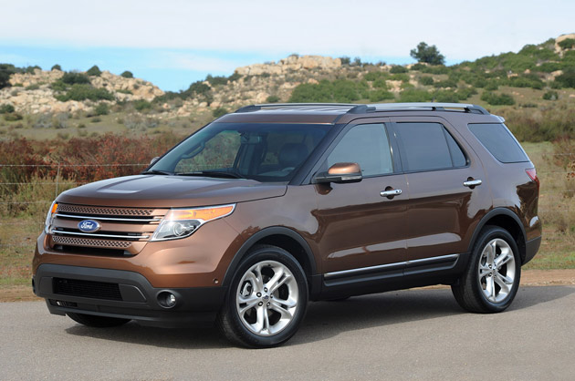 Brown 2012 Ford Explorer front three-quarters view against rocky hills